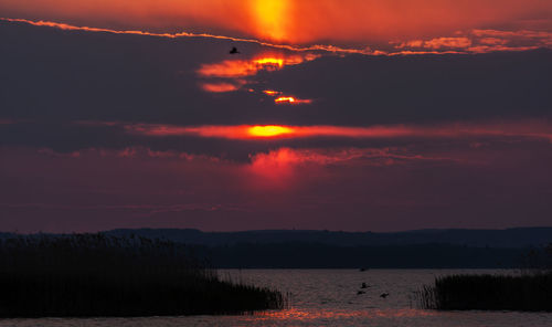 Scenic view of lake against sky during sunset