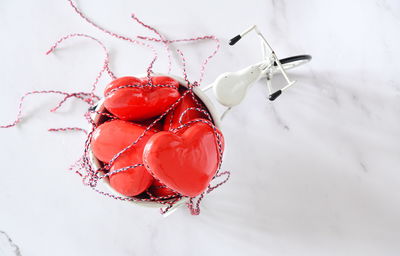 Red toy hearts in the back of a white mini bike, valentine's day concept banner