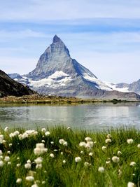 Scenic view of lake and mountains against sky