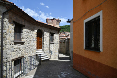 A narrow street between the old houses of sasso di castalda, a village of basilicata region, italy.