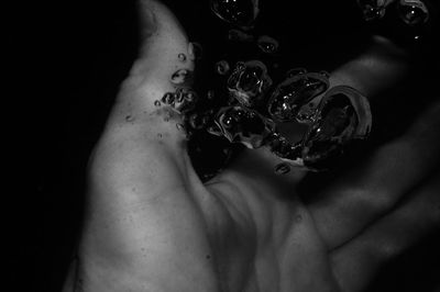 Close-up of hand on water