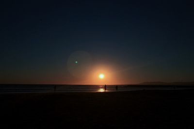 Scenic view of sea against clear sky during sunset