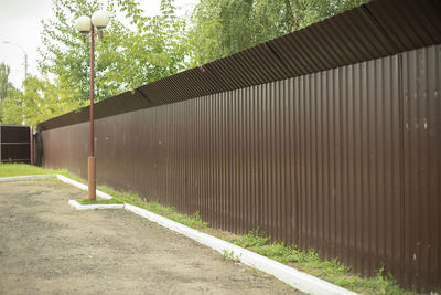 Footpath by wall in city