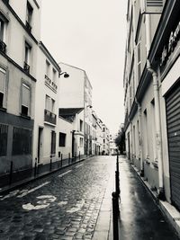 Empty alley amidst buildings in city