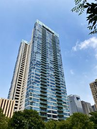 Low angle view of modern buildings against blue sky