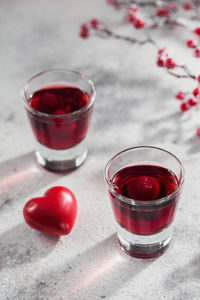 Red cocktail, vodka or liqueur and heart shape decorations