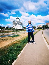 Full length of man with umbrella against sky