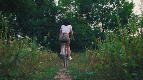 Rear view of man walking on field