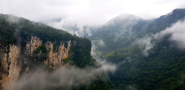 Panoramic view of trees and mountains against sky