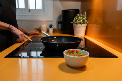 Cropped hand of person preparing food on table