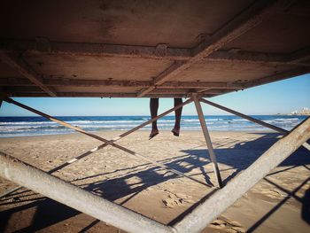 Close-up of deck chairs on beach against sky