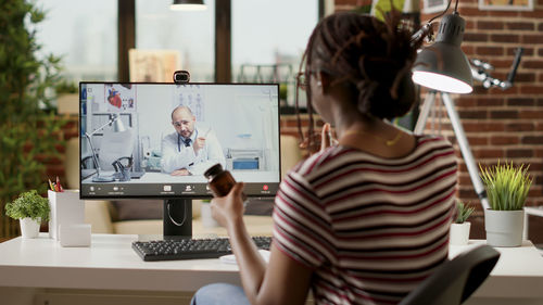 Young woman using laptop at table