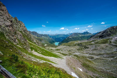 Scenic view of mountains against blue sky