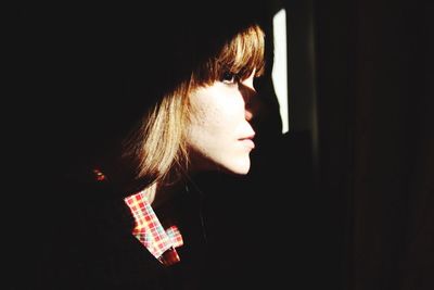 Close-up of woman looking through window