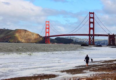 Golden gate bridge over sea against sky