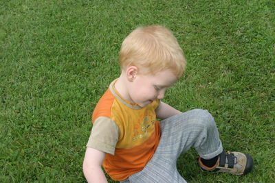 High angle view of boy playing on grassy field