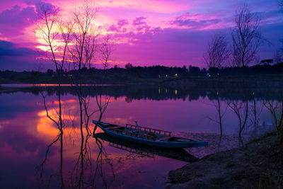 Scenic view of lake against romantic sky at sunset