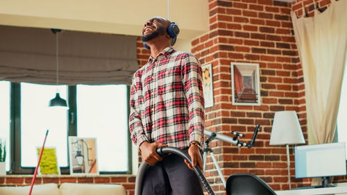 Side view of young man working at home