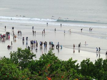 People at beach against sky