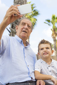 Grandfather taking selfie with grandson