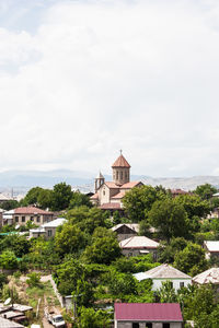 Houses against cloudy sky
