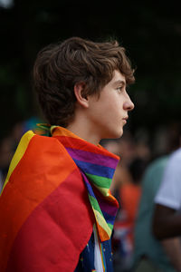 Portrait of boy with multi colored flags