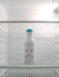 Close-up of white bottle in refrigerator