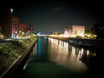 Reflection of illuminated buildings in canal at night