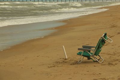 Deck chairs on sand at beach