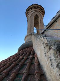 Low angle view of old building against blue sky