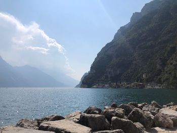 Scenic view of sea and mountains against sky