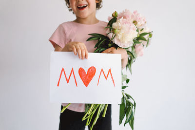 Happy mothers day. cheerful happy child with peonys bouquet.