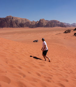 Full length of man on desert against sky