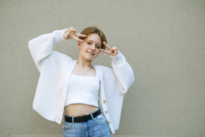 A teenage girl with a sassy short haircut and redhead charm looks off-frame