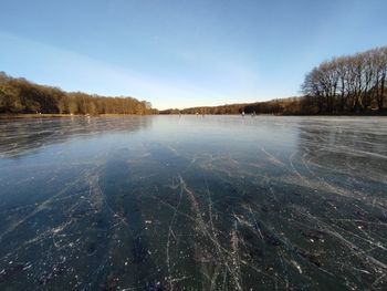 Scenic view of frozen lake against sky