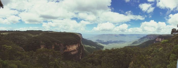 Scenic view of mountains against cloudy sky