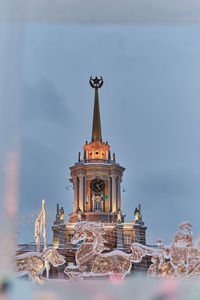  spire of yekaterinburg city administration building with lighting in frame of ice and ice figures