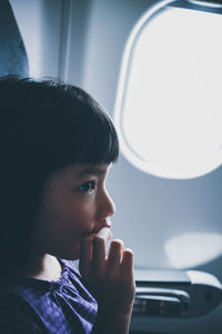 Close-up of girl traveling in airplane