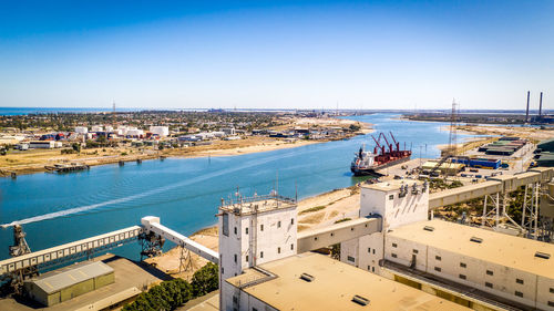 High angle view of sea and buildings against sky