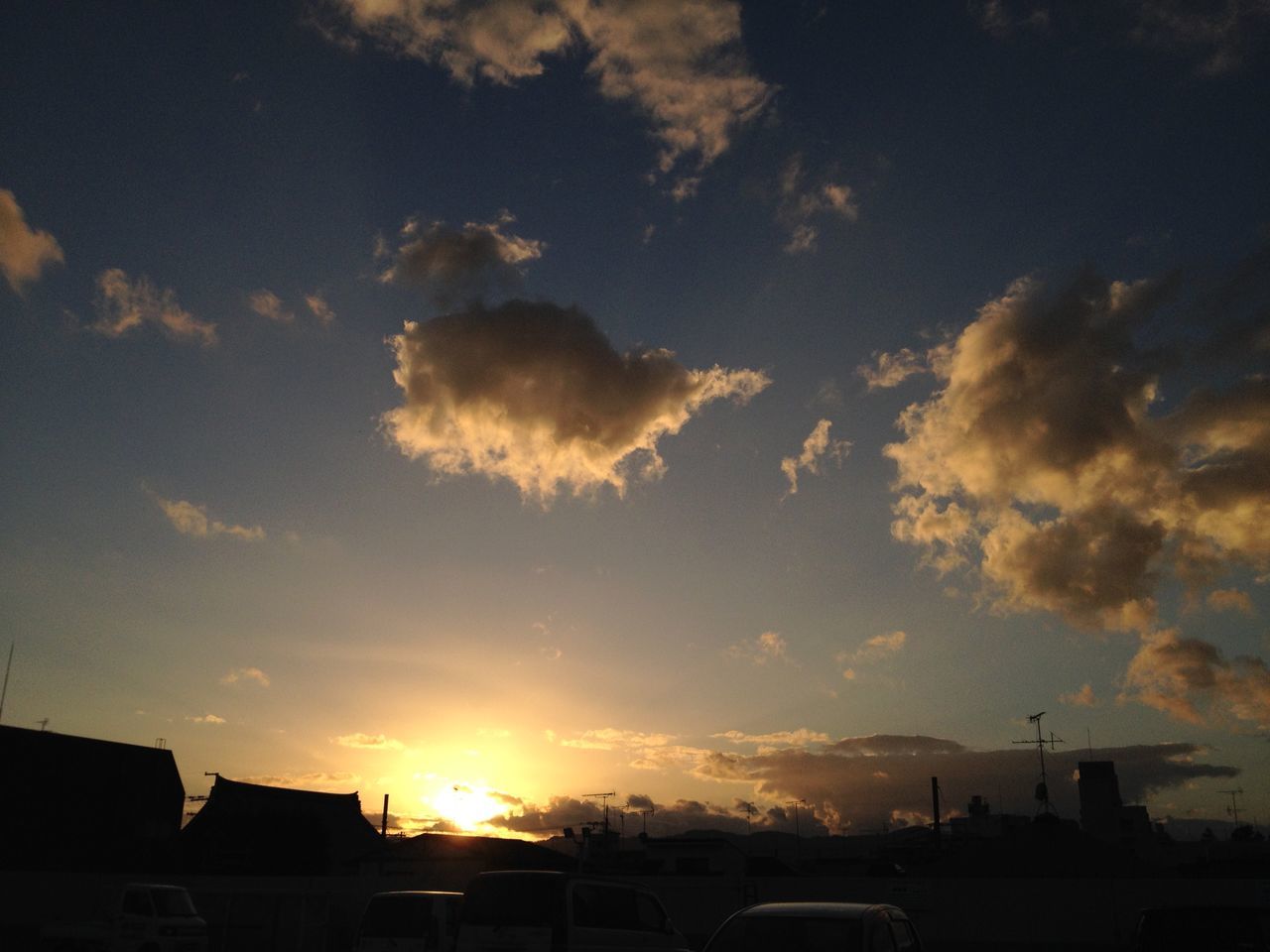 sunset, sky, cloud - sky, sun, silhouette, sunbeam, sunlight, beauty in nature, low angle view, nature, tranquility, scenics, cloud, cloudy, transportation, weather, outdoors, lens flare, tranquil scene, no people