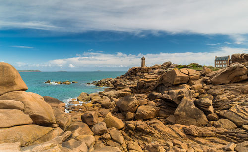 Rocks on beach against sky