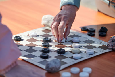 Midsection of man playing chess