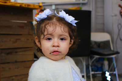 Close-up portrait of cute baby girl standing at home