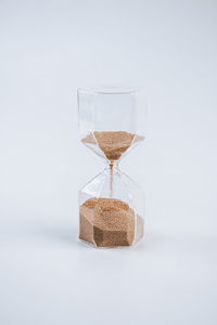Close-up of beer glass on table against white background