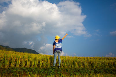 Full length of man standing on field against sky