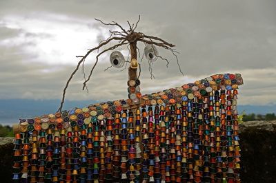 Stack of chain hanging on beach against sky