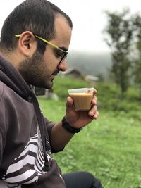 Side view of man using mobile phone