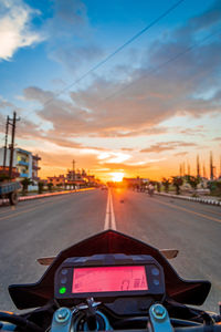 Car on street against sky during sunset