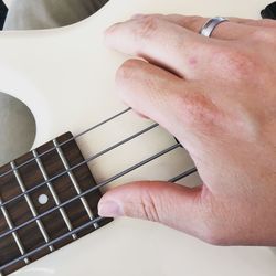 Cropped hand of man playing guitar