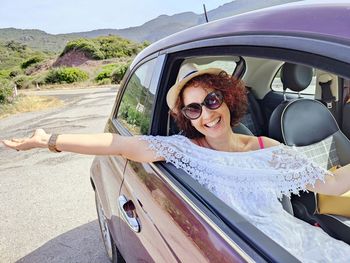 Portrait of young woman in car